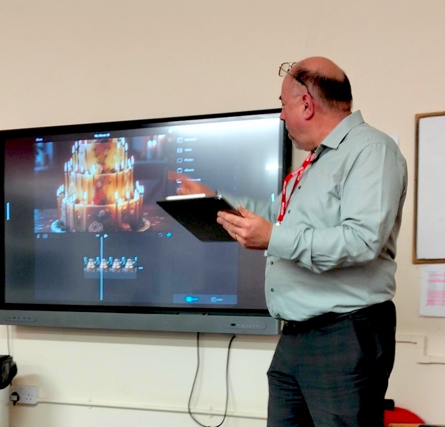 Richard Poth demonstrating multi-track video editing on an interactive display with iPad Pro